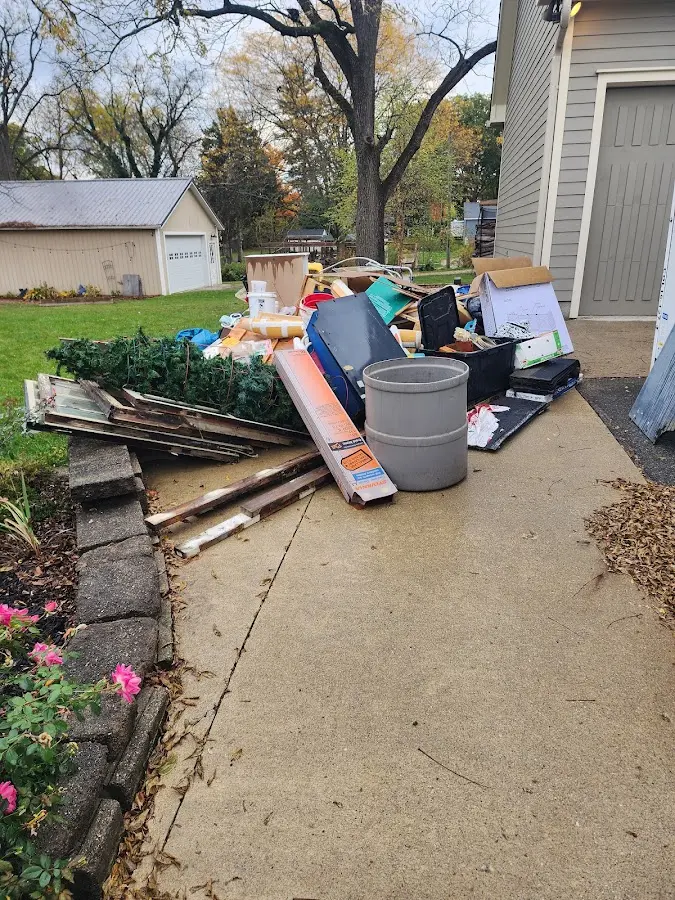 Dumpster being loaded with debris for Residential Dumpster Rental in Arlington